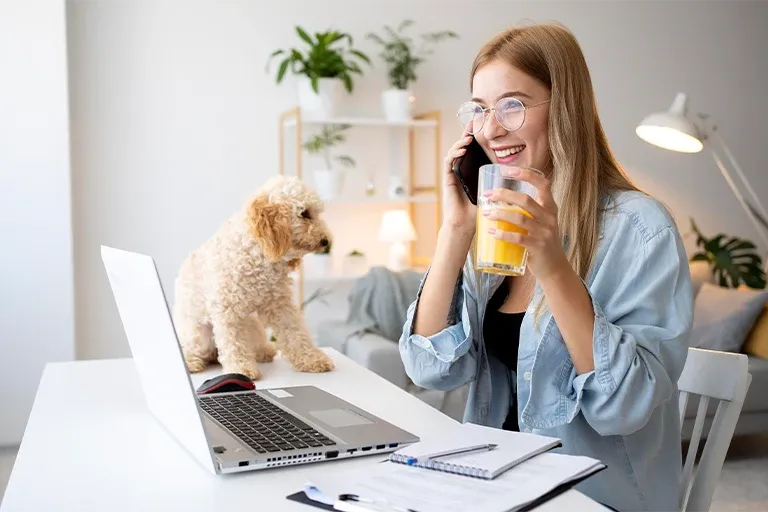 Woman at her desk with her dog